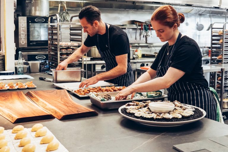 two chefs working together in a restaurant kitchen