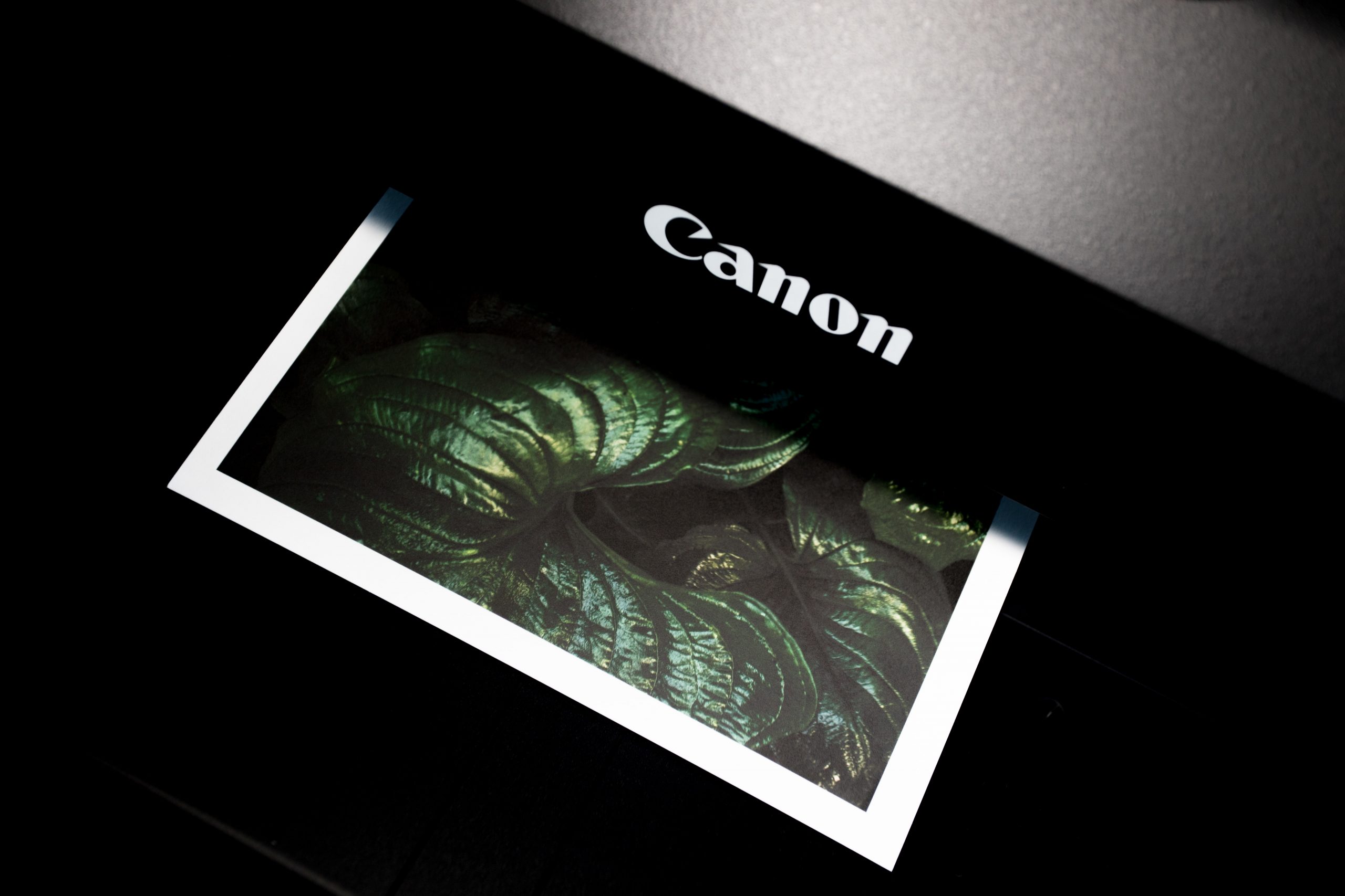 A black Canon multifunction printer & photocopier machine.